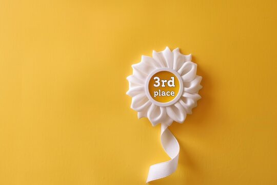 Minimalist third place award badge against a warm, sunny yellow backdrop