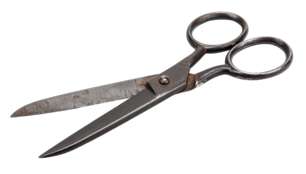 Old vintage tailor or seamstress scissors with aged metal blades and classic handle design.