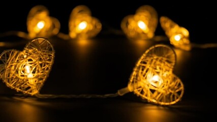 Golden Illuminated Heart-Shaped String Lights Against Black Background For Valentine's Day - Powered by Adobe