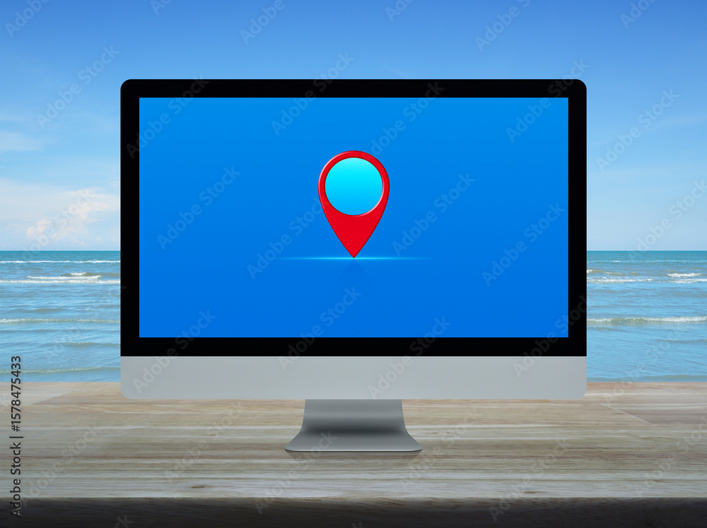 Poster map pin point location button on desktop modern computer monitor screen on wooden table over tropica