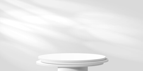 White 3D podium on a column with a wall with sunlight behind it.