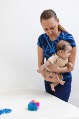 Physical therapist models proper holding posture for pediatric rehabilitation