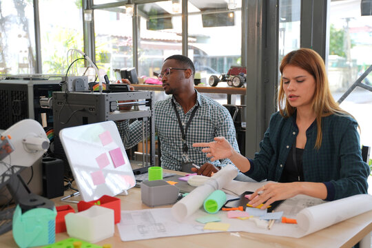 Engineers are working at 3D printing workshop.