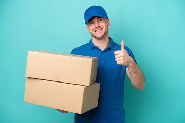 Delivery caucasian man isolated on blue background with thumbs up because something good has...
