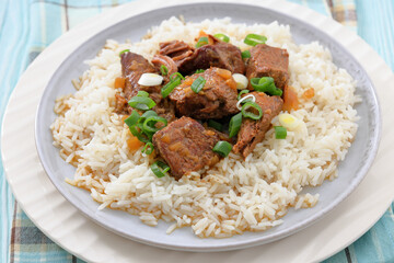 beef slow cooked with gravy served over rice
