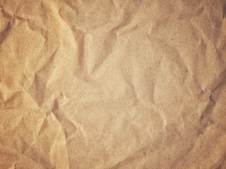Abstract crumpled and creased brown recycled paper texture with detailed surface. Crumpled old brown vintage paper surface texture. Crumpled paper background with copy space for text.