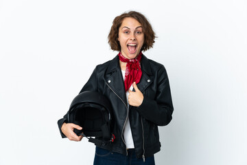 English woman holding a motorcycle helmet isolated on white background with surprise facial...