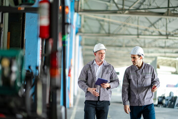 Logistics staff walking through a truck loading area outside the distribution center. The scene highlights daily transportation routines and coordination between generations.
