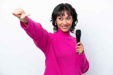Young Argentinian singer woman isolated on white background giving a thumbs up gesture