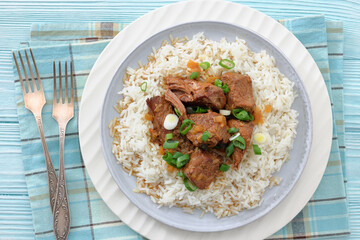 beef slow cooked with gravy served over rice