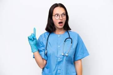 Young nurse caucasian woman isolated on white background thinking an idea pointing the finger up