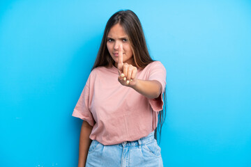 Young caucasian woman isolated on blue background counting one with serious expression