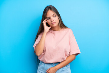 Young caucasian woman isolated on blue background with headache