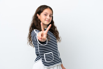 Little caucasian girl isolated on white background smiling and showing victory sign