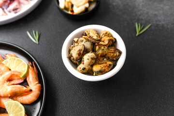 Shrimp, octopus, olives, garlic in bowls for seafood platter or tapas concept