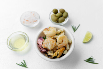 Seafood salad with rosemary and lime on white background for healthy lunch or Mediterranean snack concept