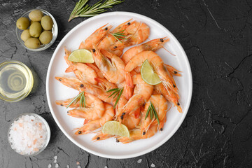 Shrimp dish with salt, olives and oil on slate background for tapas or Mediterranean appetizer concept