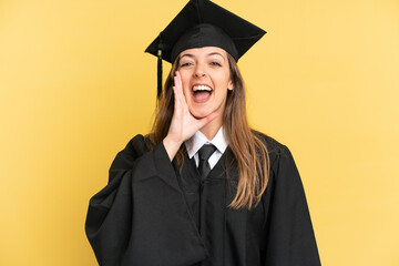 Young university graduate isolated on yellow background shouting with mouth wide open