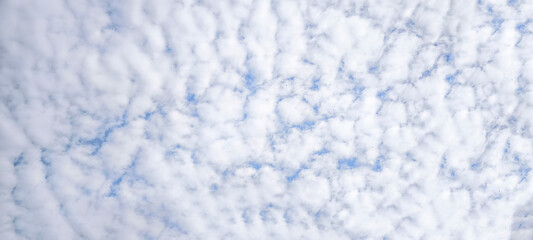 blue sky with white clouds. The sky is clear and bright