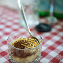 Italian traditional dessert tiramisu in a glass cup