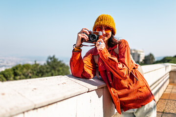 Girl with a camera. A young tourist travels around the city and films the sights on camera. The...