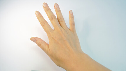 Natural Female Hand with Open Fingers on Plain Surface