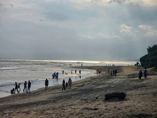 People enjoying a cloudy day at the beach