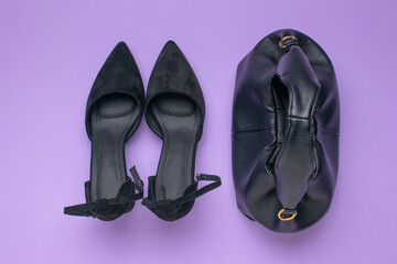 Elegant Black Heels and Handbag on Purple Background