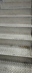 The stair treads are made of steel plates from an industrial factory.