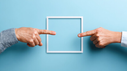 Two hands pointing at white square frame on blue background, creating symmetrical and balanced composition