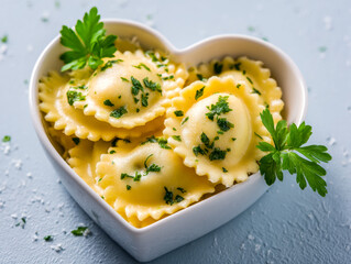 Heart-shaped bowl of ravioli garnished with fresh herbs