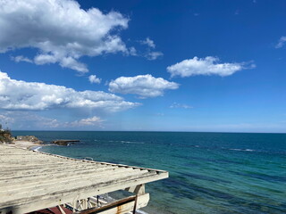 Heavenly panorama of sunlit clouds calmly floating over the boundless Black Sea.