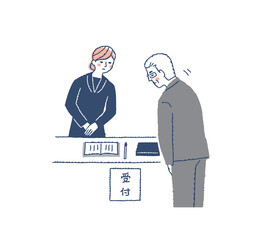 お辞儀をする弔問客の男性と受付をする女性スタッフ