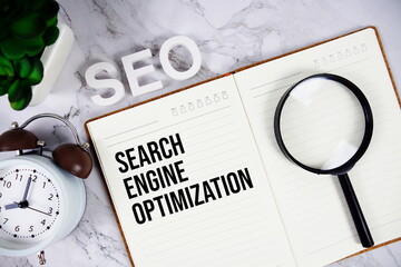 SEO - Search Engine Optimization acronym on notepad, Business concept background