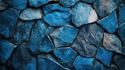 Close-up view of a wall made of textured, irregular, blue stones.