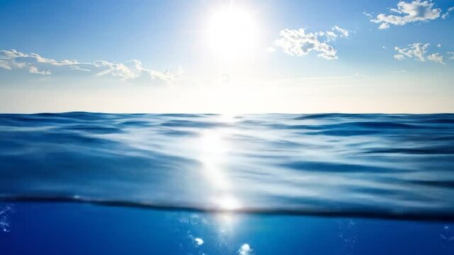Ocean's edge, sky meets sea, bubbles rise. Split-level view with sunlit clouds above, deep blue waters below. Light filters down, creating a tranquil, aquatic scene