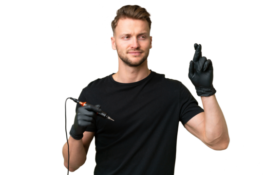 Tattoo artist caucasian man over isolated background with fingers crossing and wishing the best