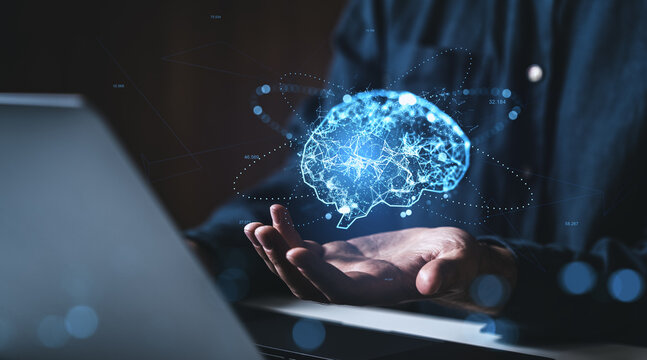 Futuristic digital brain concept above human hand symbolizing artificial intelligence, technology, and innovation in science on a dark background. - Powered by Adobe