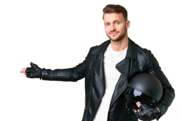 Young caucasian man with a motorcycle helmet over isolated chroma key background extending hands to the side for inviting to come