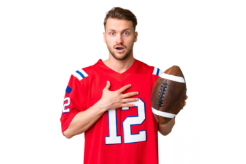 Young caucasian man playing rugby over isolated chroma key background surprised and shocked while looking right