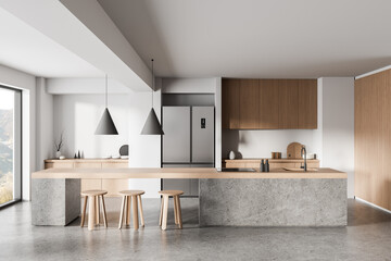 Modern minimalist kitchen interior with natural wood and concrete elements under soft lighting and...