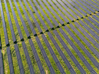 Aerial view of solar power station on a green field. Sustainable development