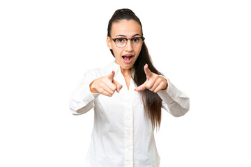 Young Arabian woman over isolated chroma key background surprised and pointing front