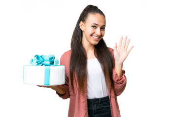 Young Arabian woman holding birthday cake over isolated chroma key background saluting with hand with happy expression