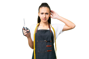 Young Seamstress woman over isolated chroma key background having doubts