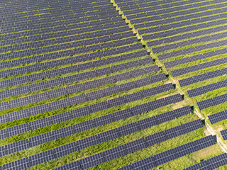 Aerial view of solar power station on a green field. Sustainable development