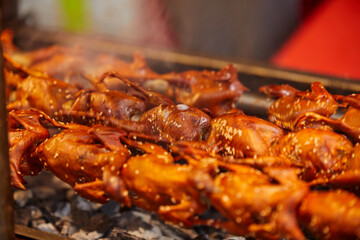 Grill skewer Quails spinning on at street food