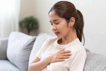  Close-up woman touching chest feeling pain heart attack symptom © Pormezz