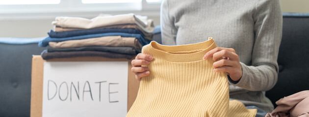 Organize closet and storage concept, people prepare unwanted old fashion clothes for share donation.