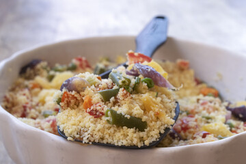 vegetarian couscous salad with roasted vegetables in ceramic bowl